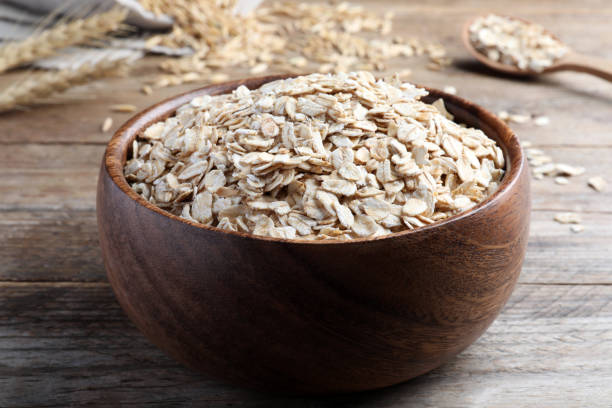 istock Bowl with oatmeal on wooden table, closeup 1423354229