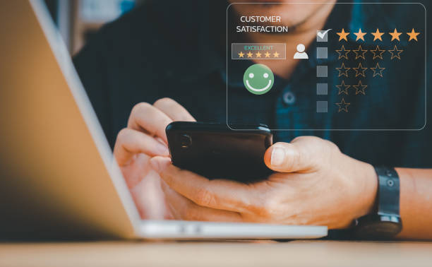 istock Man is rating for customer service satisfaction via mobile phone. 1423354397