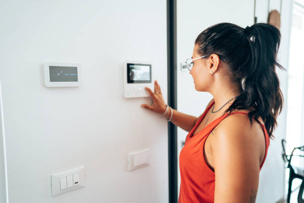 istock woman at the intercom at home 1423354557