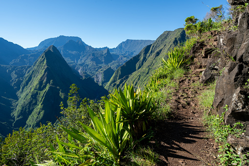 View of the mountain peaks and tourist path on the hill, in Reunion Island in the summertime