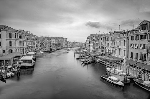 Venice, Italy - July 4, 2021: view from Rialto bridge to canale grande in Venice with ships in motion, Italy.