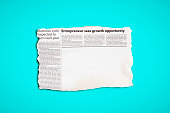 istock Cutting from a newspaper, with plenty of space for your copy, on turquoise-aquamarine blue background 1423359948