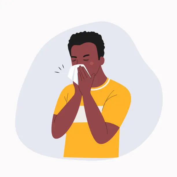 Vector illustration of Young ill man with dark skin blows his nose in a handkerchief isolated. Vector flat style cartoon illustration