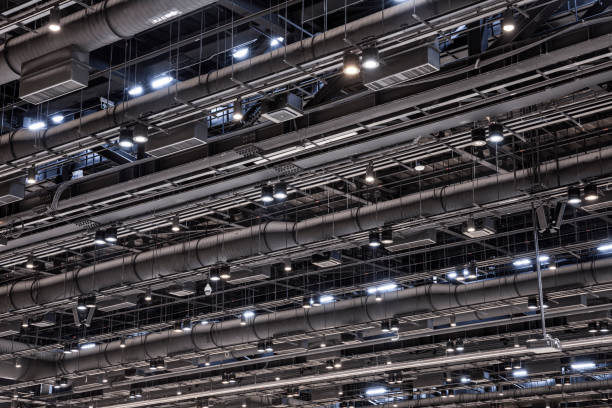 istock HVAC Duct Cleaning, Ventilation pipes in silver insulation material hanging from the ceiling inside new building. 1423365777