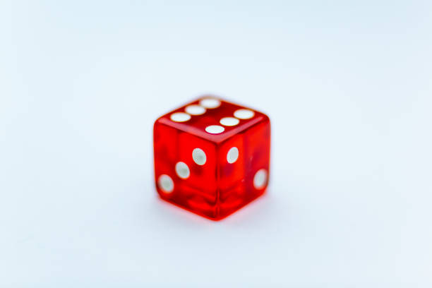 UK, September 2022, Red casino Dice showing the number six on top