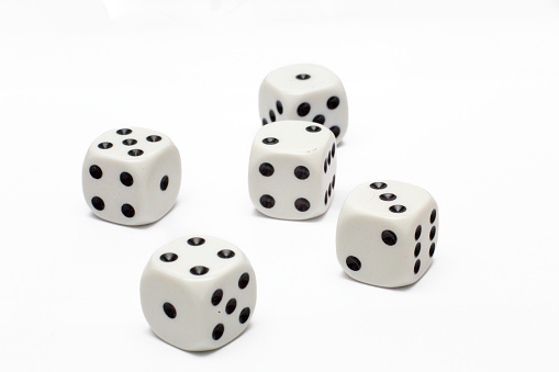 UK, September 2022, white dice with black spots: Five dice with numbers one, two, three, four and five on top