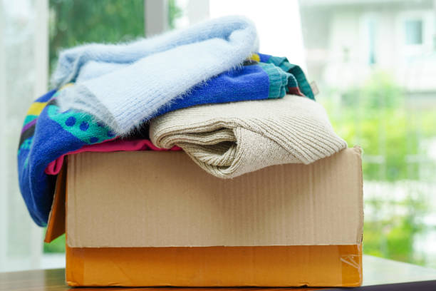 istock Clothes donations in cardboard box for volunteer. 1423368728