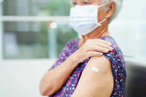 Asian elder senior woman getting vaccine for protect corona virus.