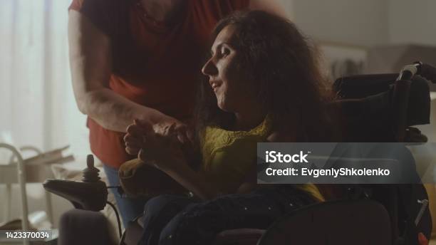 Mother Helping Daughter With A Disability Stock Photo - Download Image Now - Mobility Scooter, Senior Adult, Senior Animal