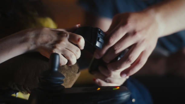 Man helping woman with disability with gamepad