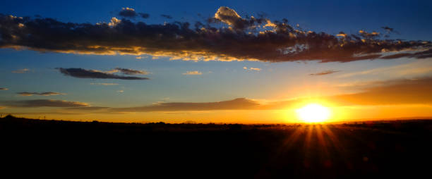 istock Sun Setting Sunset or Rise Sunrise with Sunstar Rays of Light with Clouds in Sky 1423371989