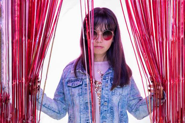 latin teen girl with glasses and colored lights with a party curtain - pre teen boy flash imagens e fotografias de stock