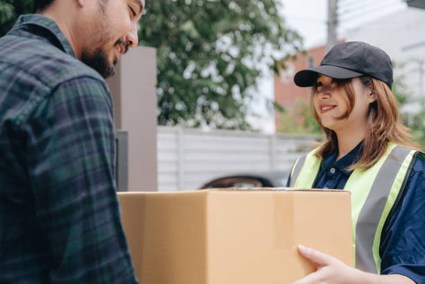 istock Young man signing on digital device that he received a delivery parcel 1423373690