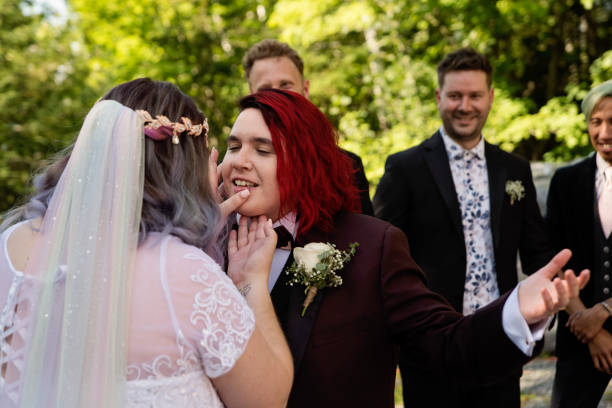 istock Lesbian brides at LGBTQ+ wedding ceremony outdoors in summer. 1423375659