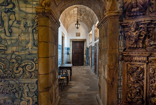 Interior of Viseu Cathedral. Blue Mosaics with tiles and entrances with arches decorated with religious faces carved in wood