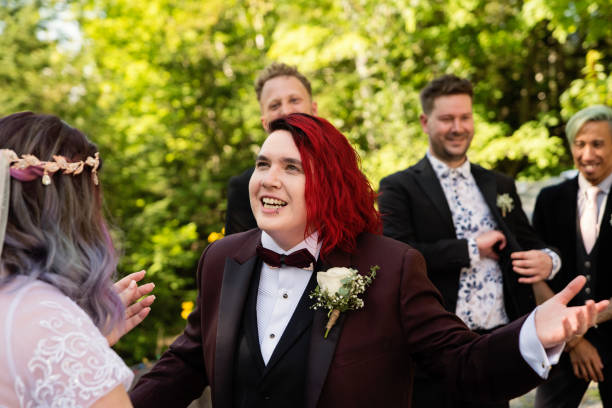 istock Lesbian brides at LGBTQ+ wedding ceremony outdoors in summer. 1423375978