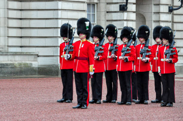 London, UK - June 25 2024: King's Guards march near Buckingham Palace with rifles.