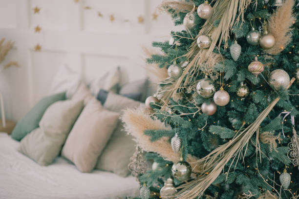 istock Gold balls on a Christmas tree with a bed and pillows in the background 1423379083