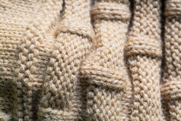 textured macro brown sweater,Seamless texture of handmade knitting of natural yarn. Sheep common wool. Knitted background. Closeup textured macro brown sweater,Seamless texture of handmade knitting of natural yarn. Sheep common wool. Knitted background. Closeup knitting textile wool infinity stock pictures, royalty-free photos & images