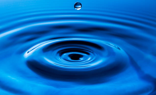 istock macro water drop,Blue splash water droplets round water droplets in glass drops, splashes, sprays, abstract shapes out of water 1423382469