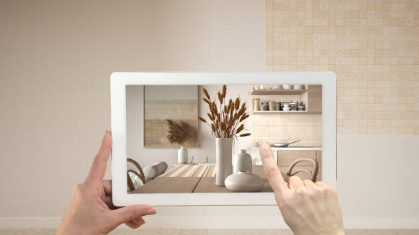 istock Augmented reality concept. Hand holding tablet with AR application used to simulate furniture and design products in empty interior with ceramic tiles. Dining room, table, chairs 1423382637