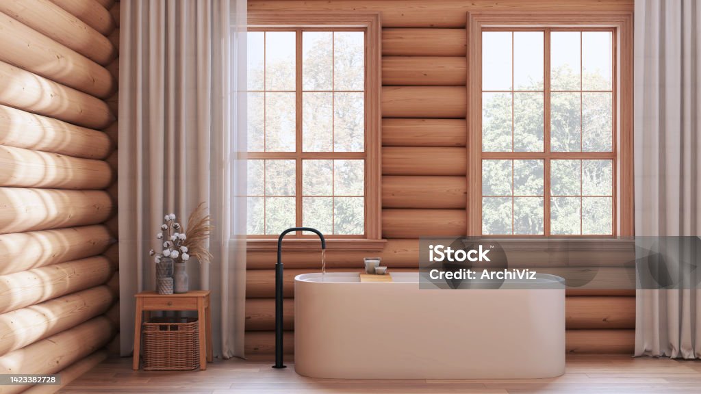 Wooden farmhouse log cabin in white and beige tones. Vintage bathroom with bathtub, panoramic windows, rustic interior design Bathtub Stock Photo