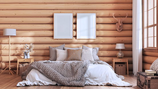 Log cabin bedroom in white and beige tones. Double bed with blanket and duvet, wooden side tables. Frame mockup, farmhouse interior design