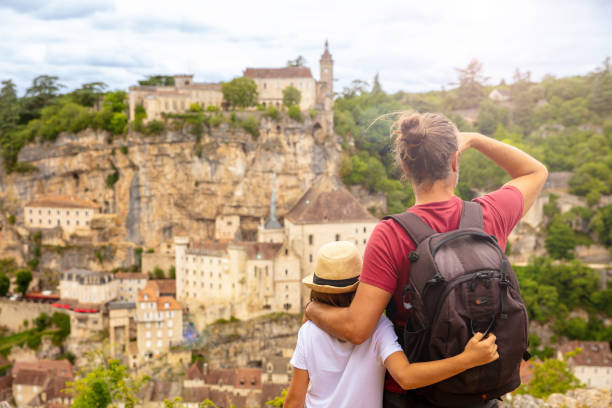 children and father looking panoramic view of rocamadour- france - lot imagens e fotografias de stock