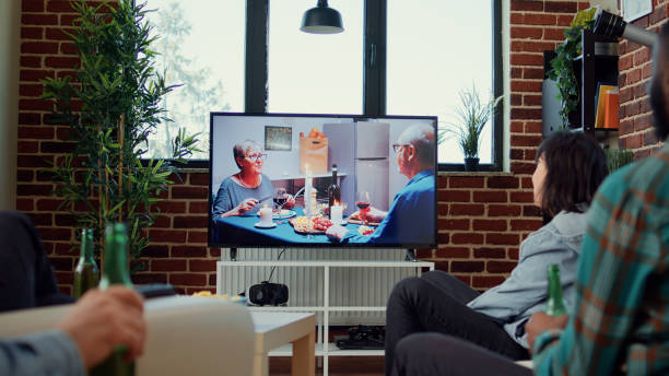 istock Diverse people having fun watching drama movie on television 1423384452