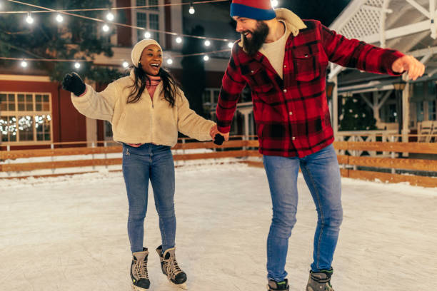 istock Smiling couple ice skating 1423384659