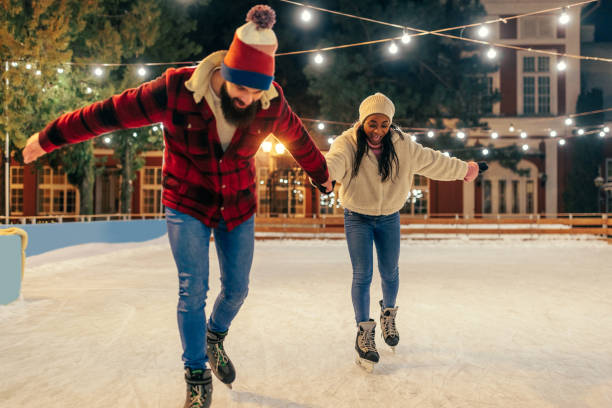 istock Multiracial couple enjoying ice skating 1423384661