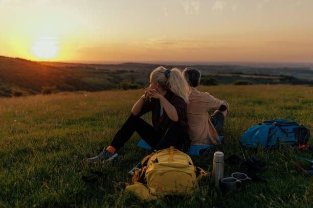 istock A middle aged couple enjoying sunset after trekking 1423384685