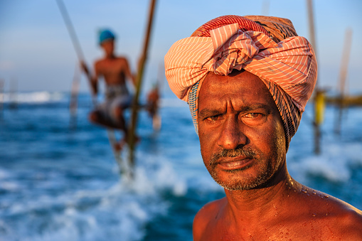 A close-up of a stilt fisherman on a beach near Galle town, Sri Lanka, Asia