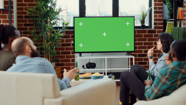 istock Diverse people watching movie on television with greenscreen 1423385237