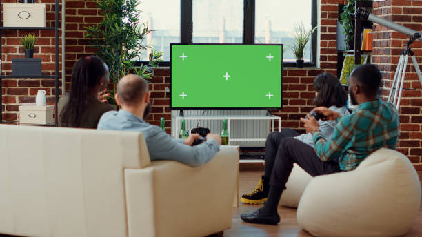 istock Happy friends playing video games on greenscreen background 1423385309