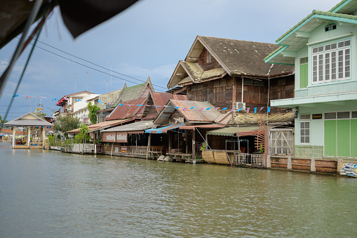 Samut Songkhram, Thailand - September 06, 2022 : Resident and housing at Ampahwa floating market. Amphawa is one of the most famous floating markets in the world it 's close all shop on monday to Friday