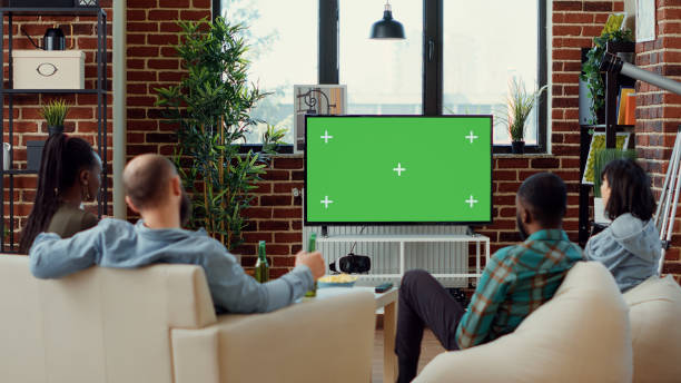 istock Diverse friends watching tv series on greenscreen template 1423386340