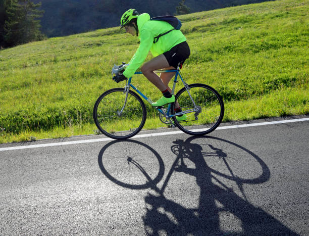 istock young cyclist with racing bicycle and phosphorescent waterproof jacket on the road 1423386470