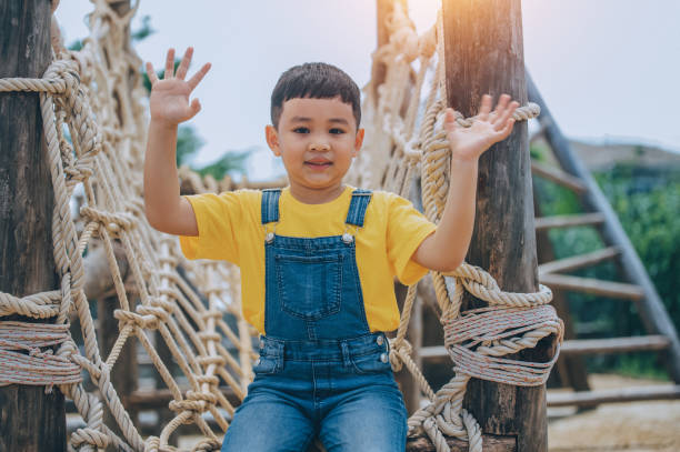 istock Asian boy playing  in playground 1423386491