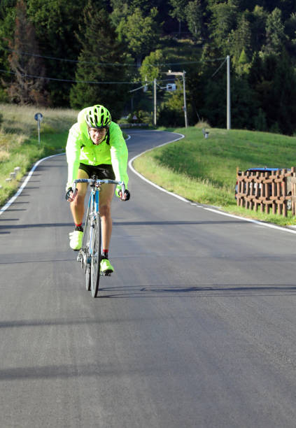 istock cyclist with racing bicycle and waterproof jacket 1423386569
