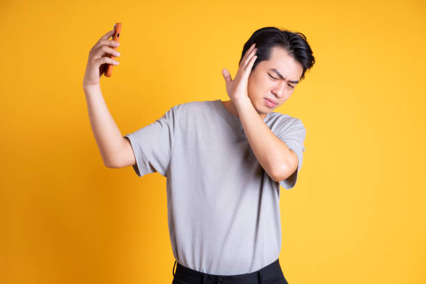 istock Asian young man posing on a yellow background 1423386785