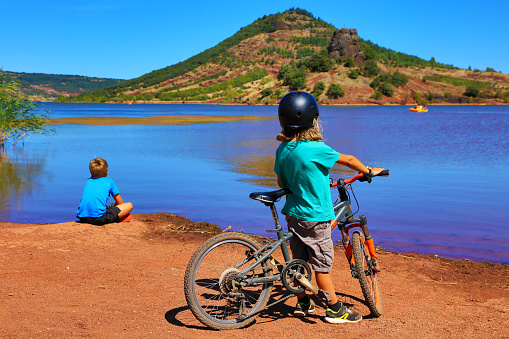 children on bike on Salagou lake( Herault in France)