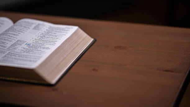 istock Bible bottom corner on wood table 1423388872