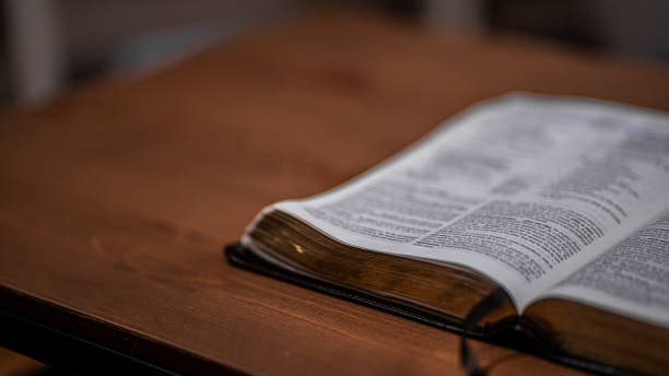 istock Bible bottom corner on wood table 1423388947