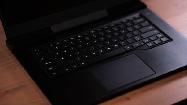 istock Laptop Keyboard on wood background 1423388962