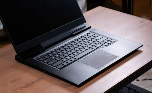 istock Laptop Keyboard on wood background 1423388972
