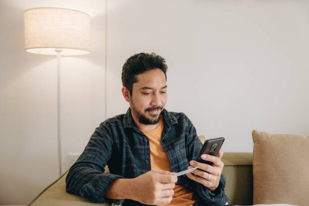 istock Mature man using cellphone for shopping online 1423389287