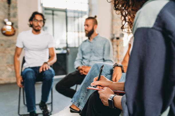 istock A mental health professional is taking notes during a group therapy session 1423390073