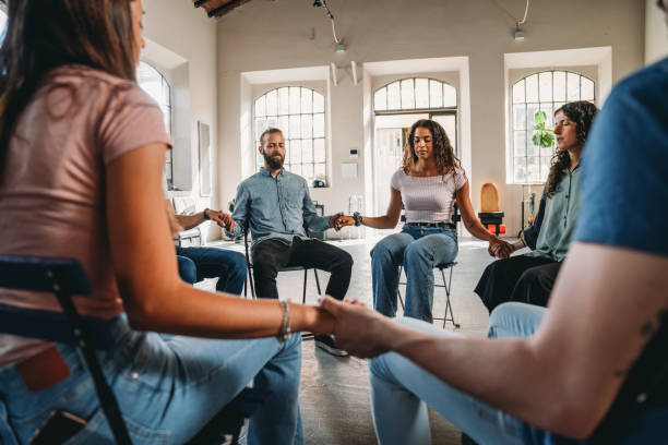 istock People are meditating together during a group therapy session 1423390090