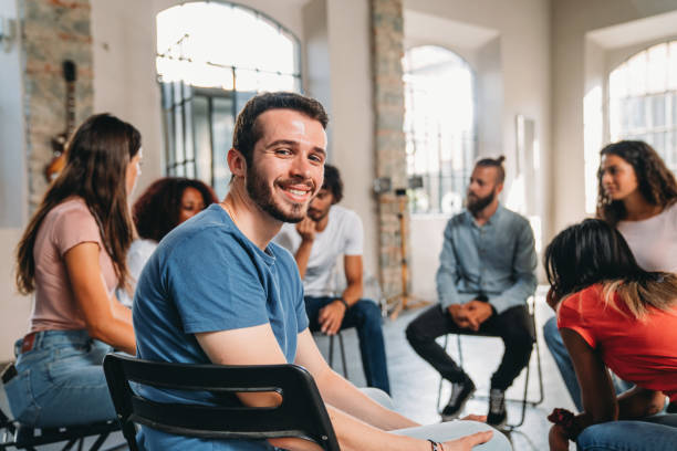 istock Portrait of a man looking at camera during a group therapy session 1423390145